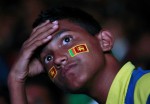 Fan of Sri Lankan cricket team reacts as he watches telecast of ICC Cricket World Cup final match in Colombo